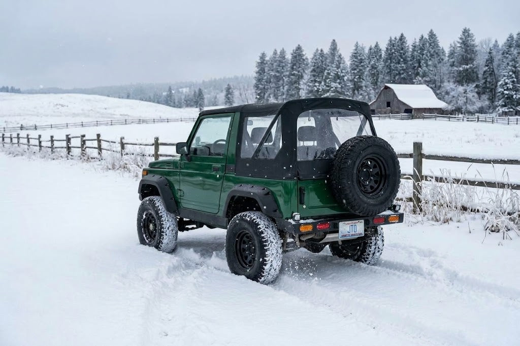 Green Suzuki Samurai in a snowy field